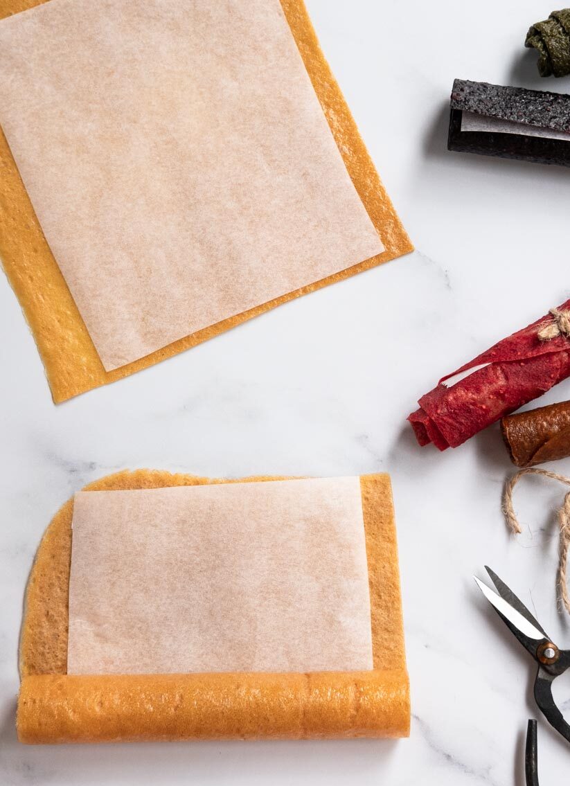 Cut the dried fruit leather and line with parchment paper.  Roll up and tie with butchers twine.